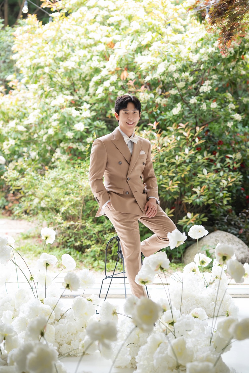 Kavalier client in a custom suit at a real garden wedding
