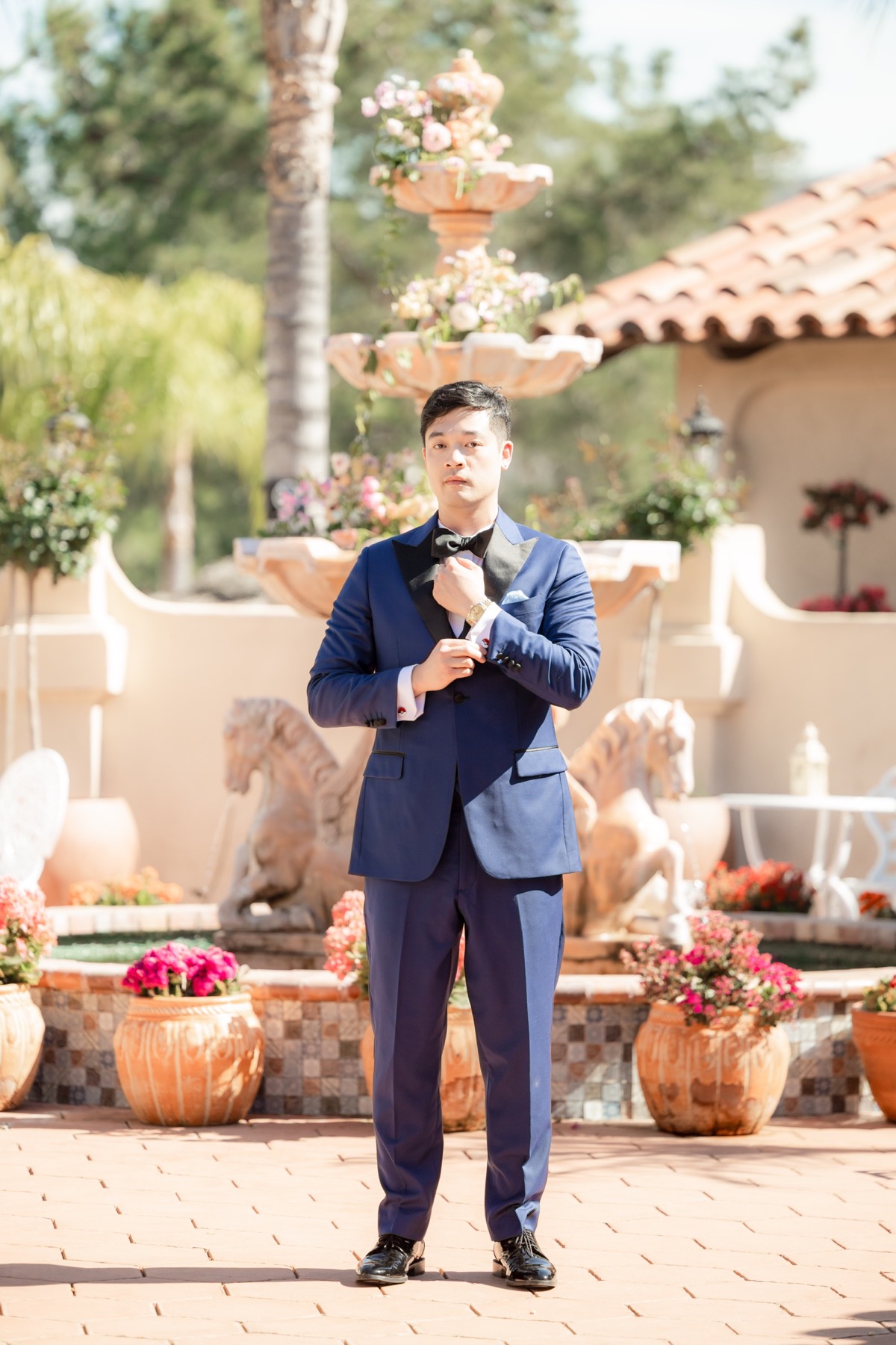 Michael Tran in a custom blue Kavalier wedding tuxedo, showing the full formal look